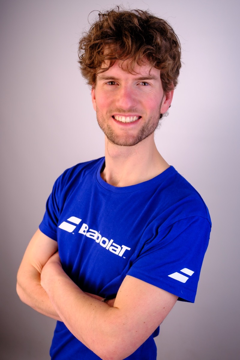 Josh, founder of Americano Club, smiling with arms crossed